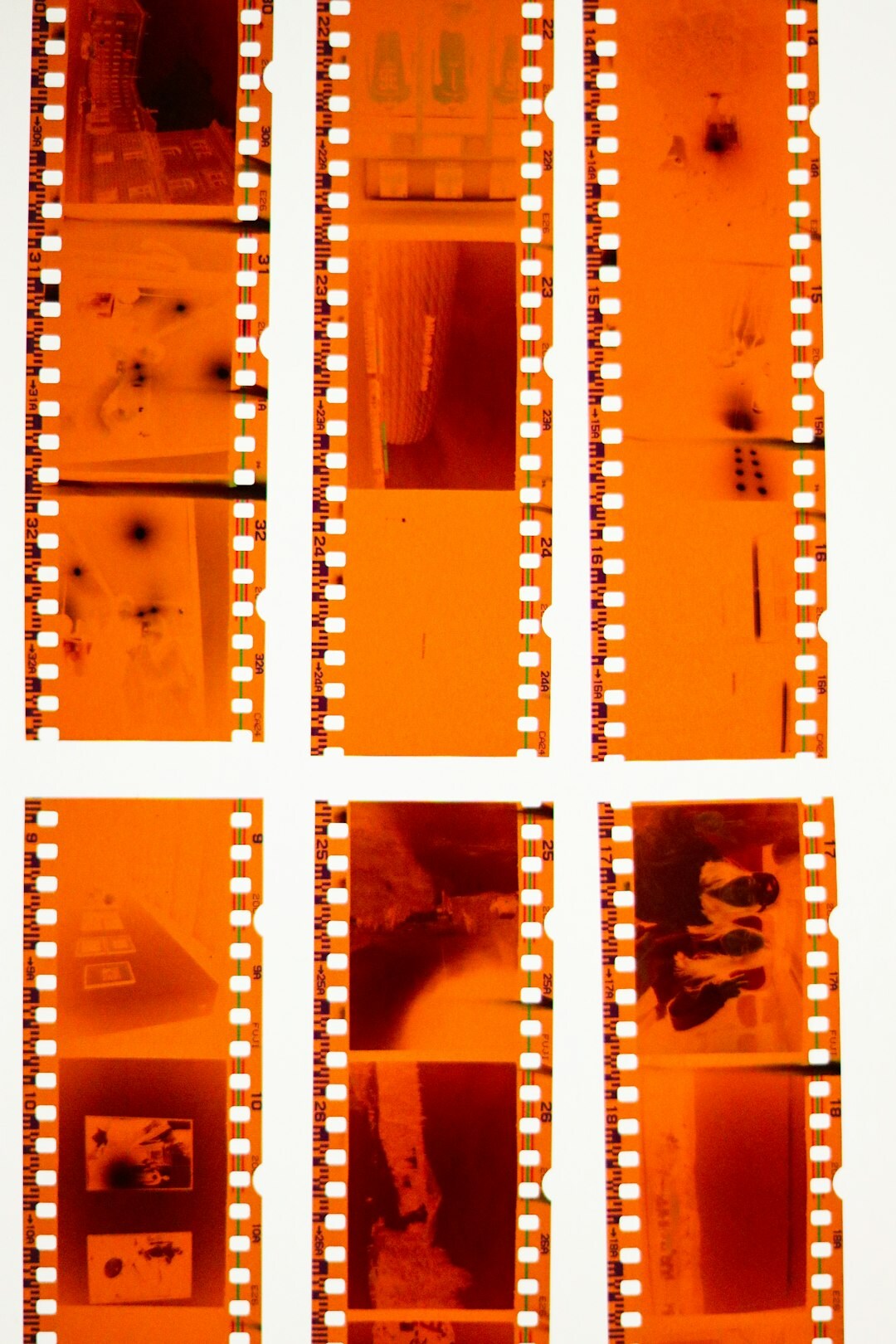 Stack of old magazines and negatives on a wooden archive table